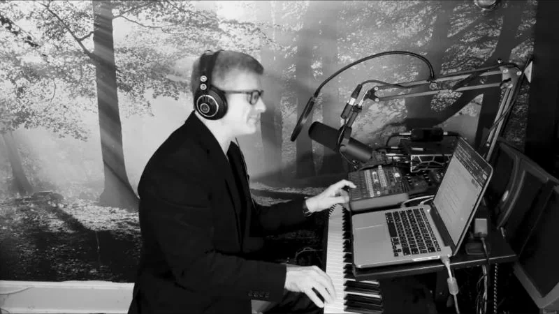 Luis at the piano and microphone, recording the El Cid trailer